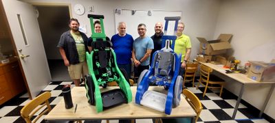 Group of volunteer 3D printers shown with Toddler Mobility Trainers